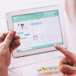 Elderly patient having online consultation with doctor on his tablet computer